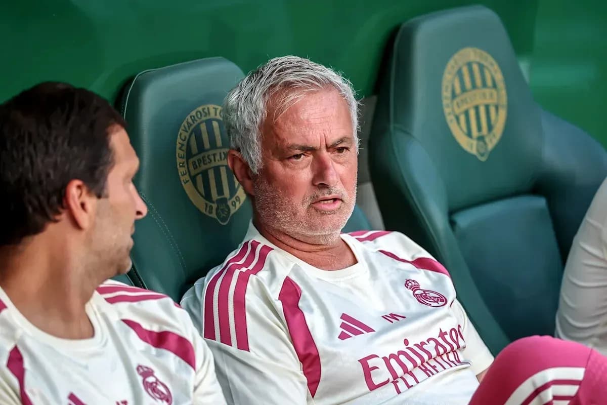 Manager and player sitting on team bench Manager and player sitting on team bench