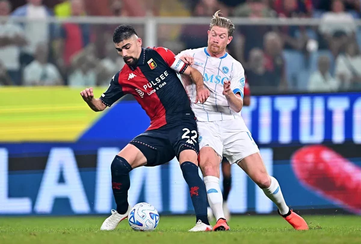 Genoa player battling Napoli player for possession Genoa player battling Napoli player for possession