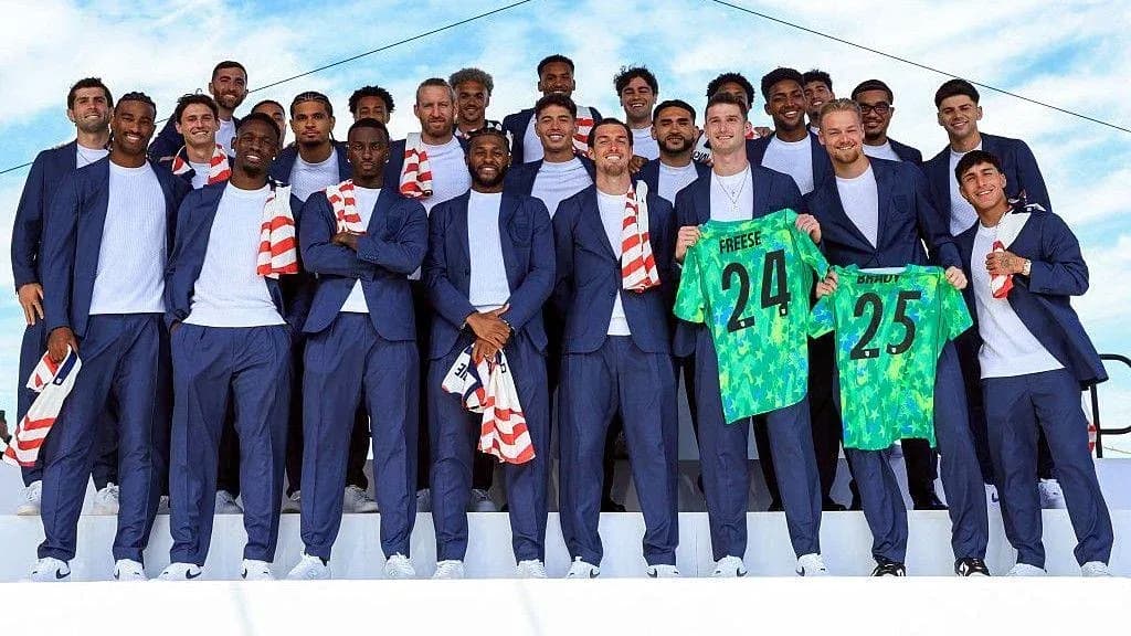 Soccer team posing with jerseys at event Soccer team posing with jerseys at event