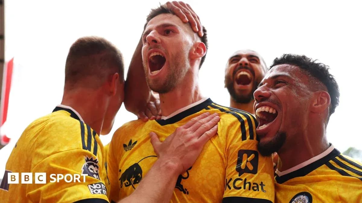 Players celebrating a goal in yellow jerseys Players celebrating a goal in yellow jerseys