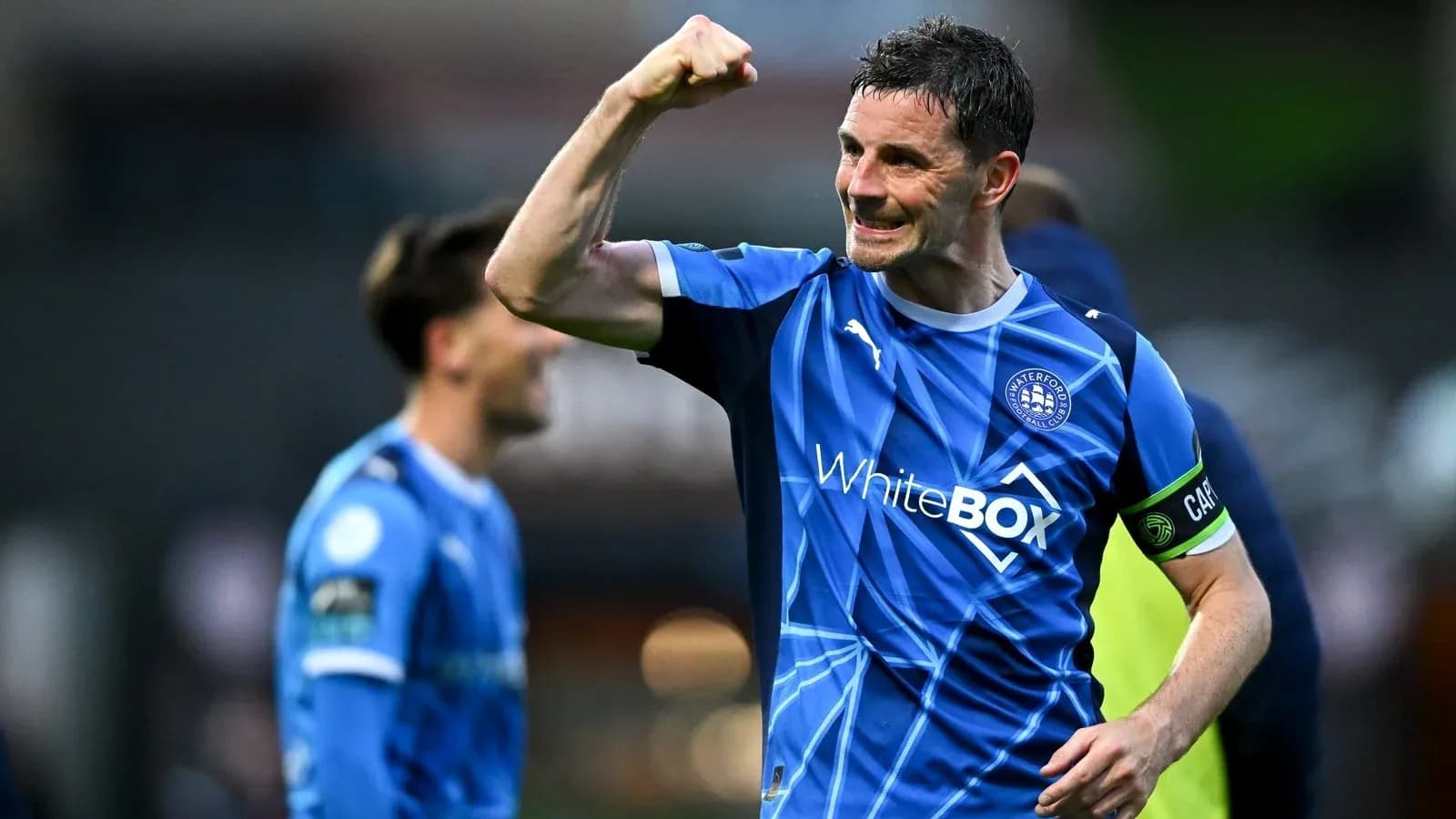 Player celebrating victory with a raised fist Player celebrating victory with a raised fist