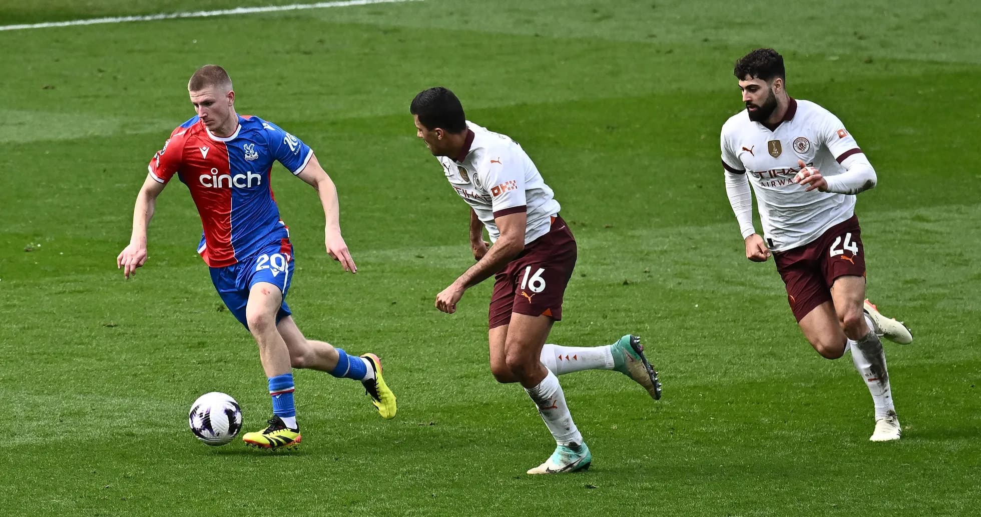 Crystal Palace player dribbling past two opponents Crystal Palace player dribbling past two opponents