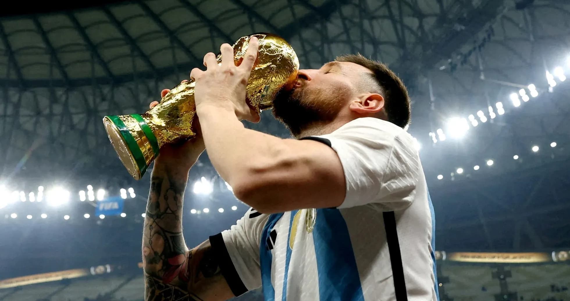 Player celebrating by kissing the World Cup trophy Player celebrating by kissing the World Cup trophy