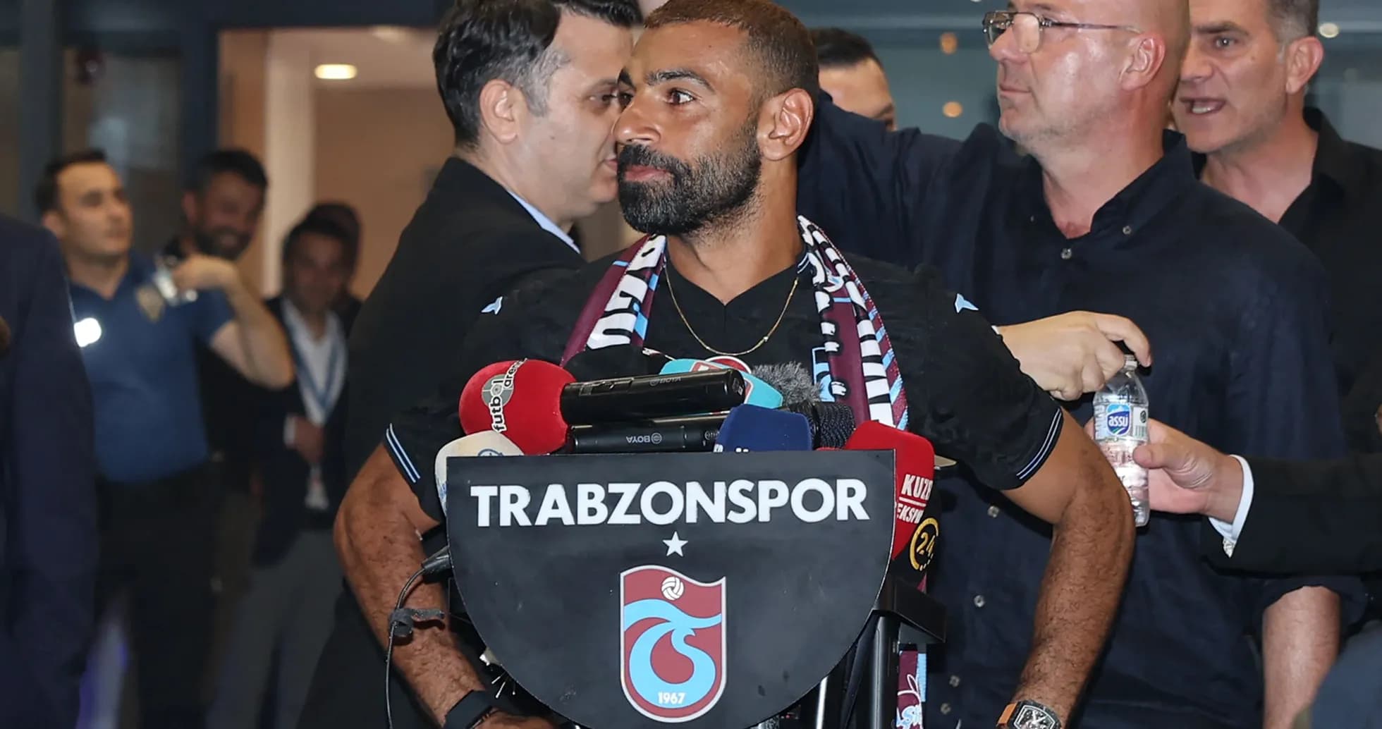 Player at press conference with Trabzonspor logo Player at press conference with Trabzonspor logo