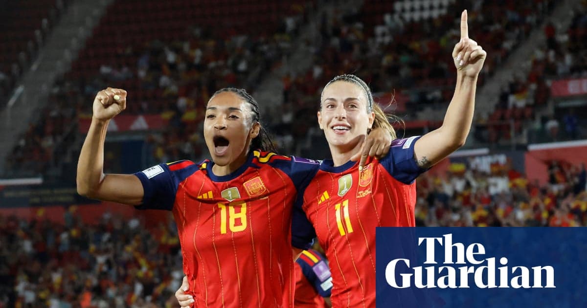 Two Spanish players celebrating a goal together Two Spanish players celebrating a goal together