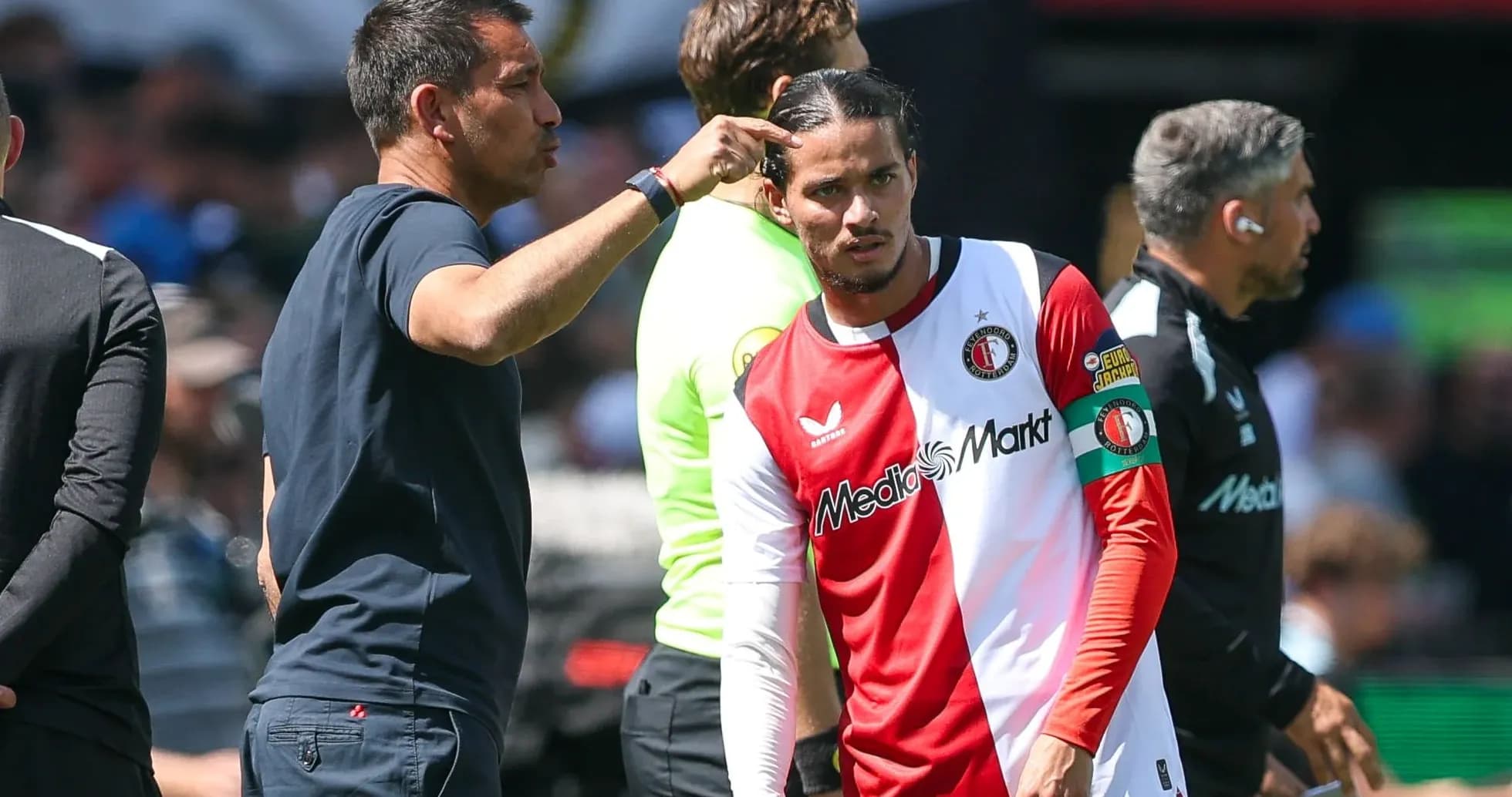 Coach giving instructions to player before substitution Coach giving instructions to player before substitution