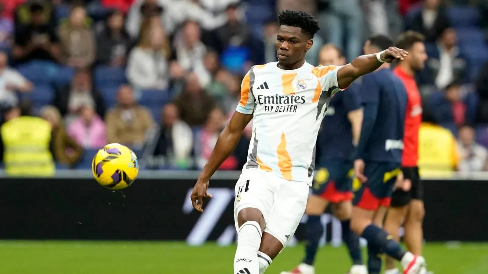 Player in Real Madrid kit kicking a football Player in Real Madrid kit kicking a football