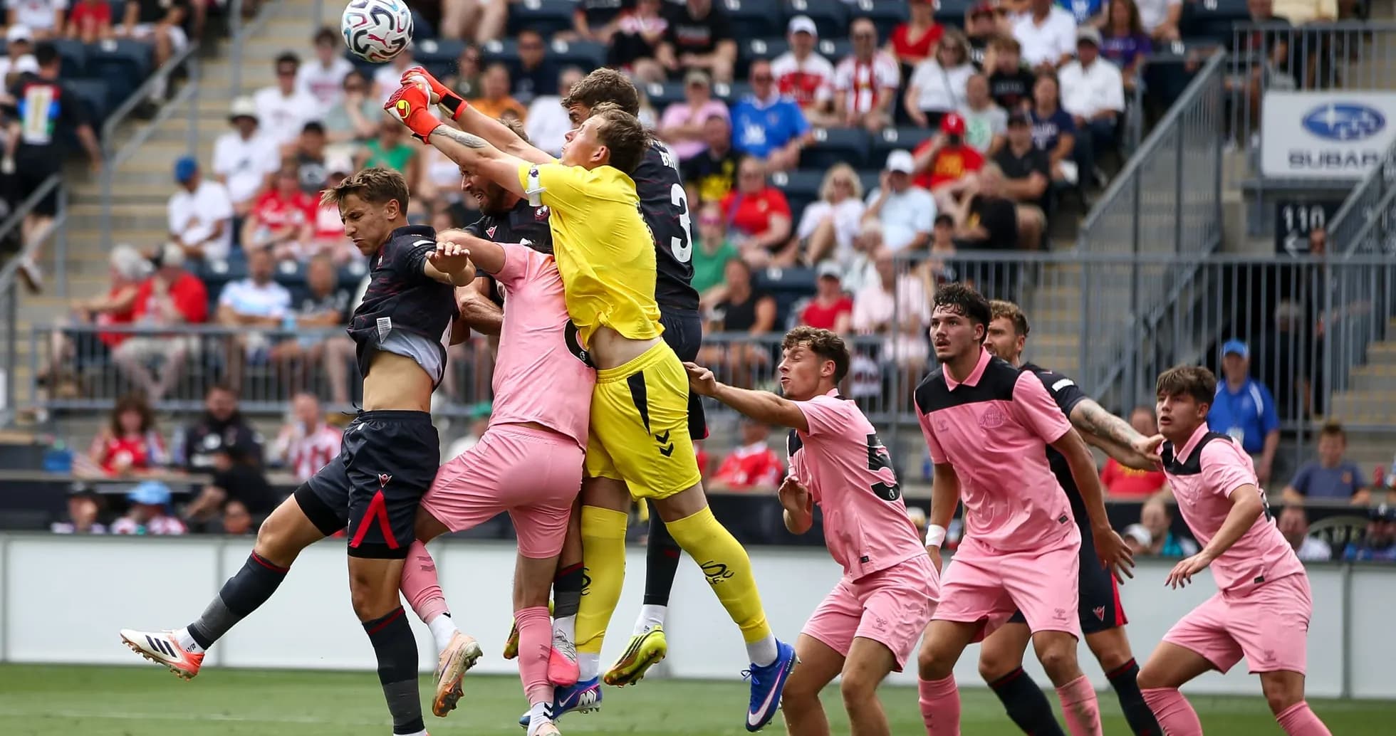Goalkeeper jumping to catch the ball during match Goalkeeper jumping to catch the ball during match