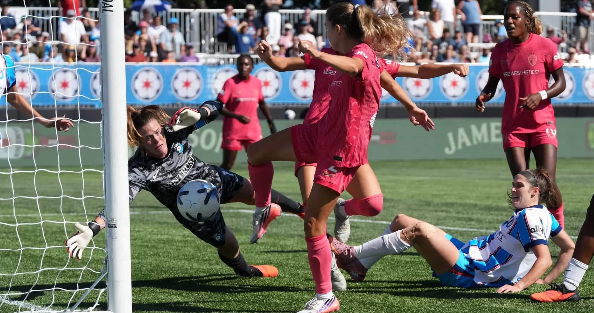 Goalkeeper attempting to save shot during match Goalkeeper attempting to save shot during match