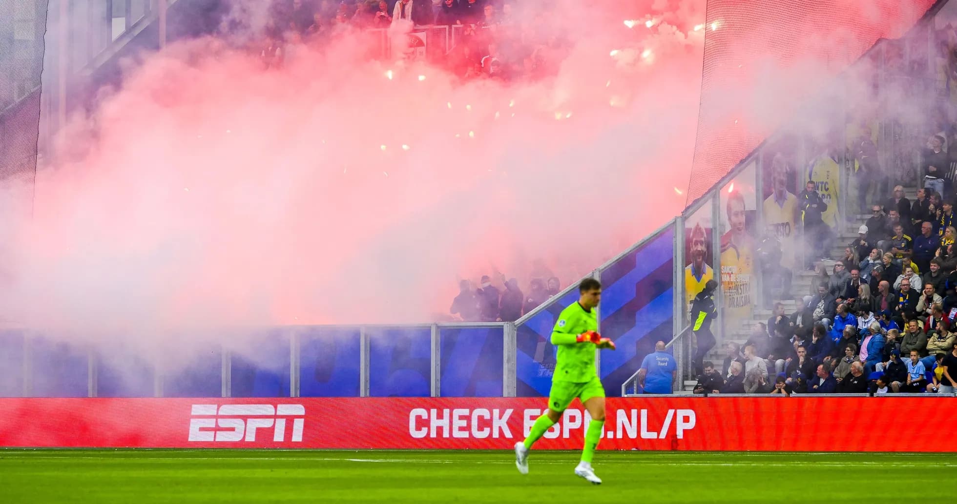 Goalkeeper walking past smoke during match celebration Goalkeeper walking past smoke during match celebration