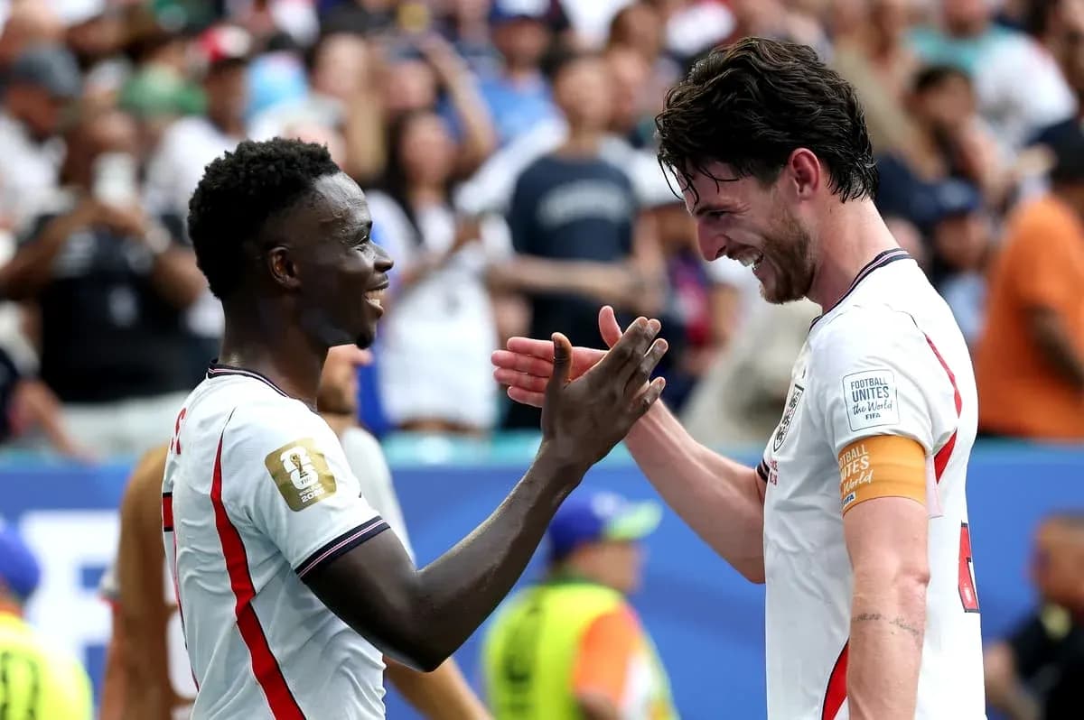 Two players celebrating with a handshake on field Two players celebrating with a handshake on field